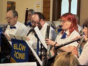 Members of Blowzone at a n indoor performance November 2025