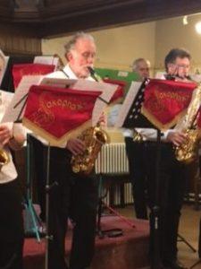 close up of two members of the band showing the red banners for the music stands